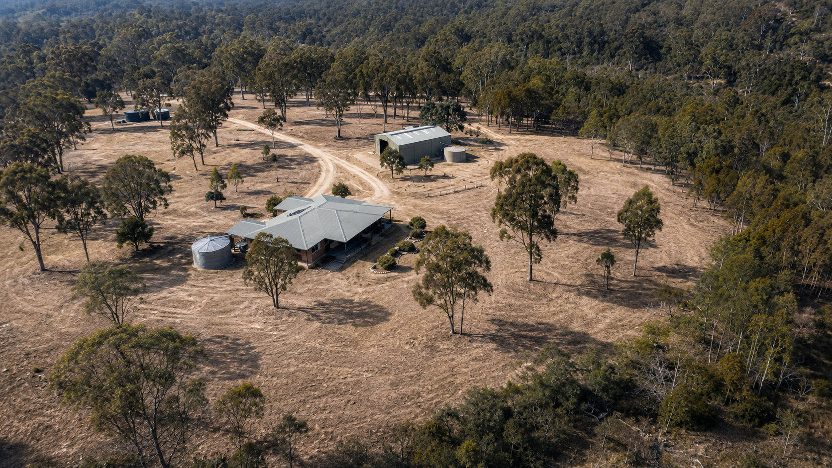 Aerial view of a cleared defendable space around a rural home
